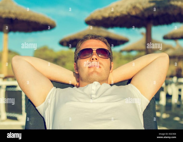 man-sunbathing-on-the-beach-vacation-EGCXE8.jpg
